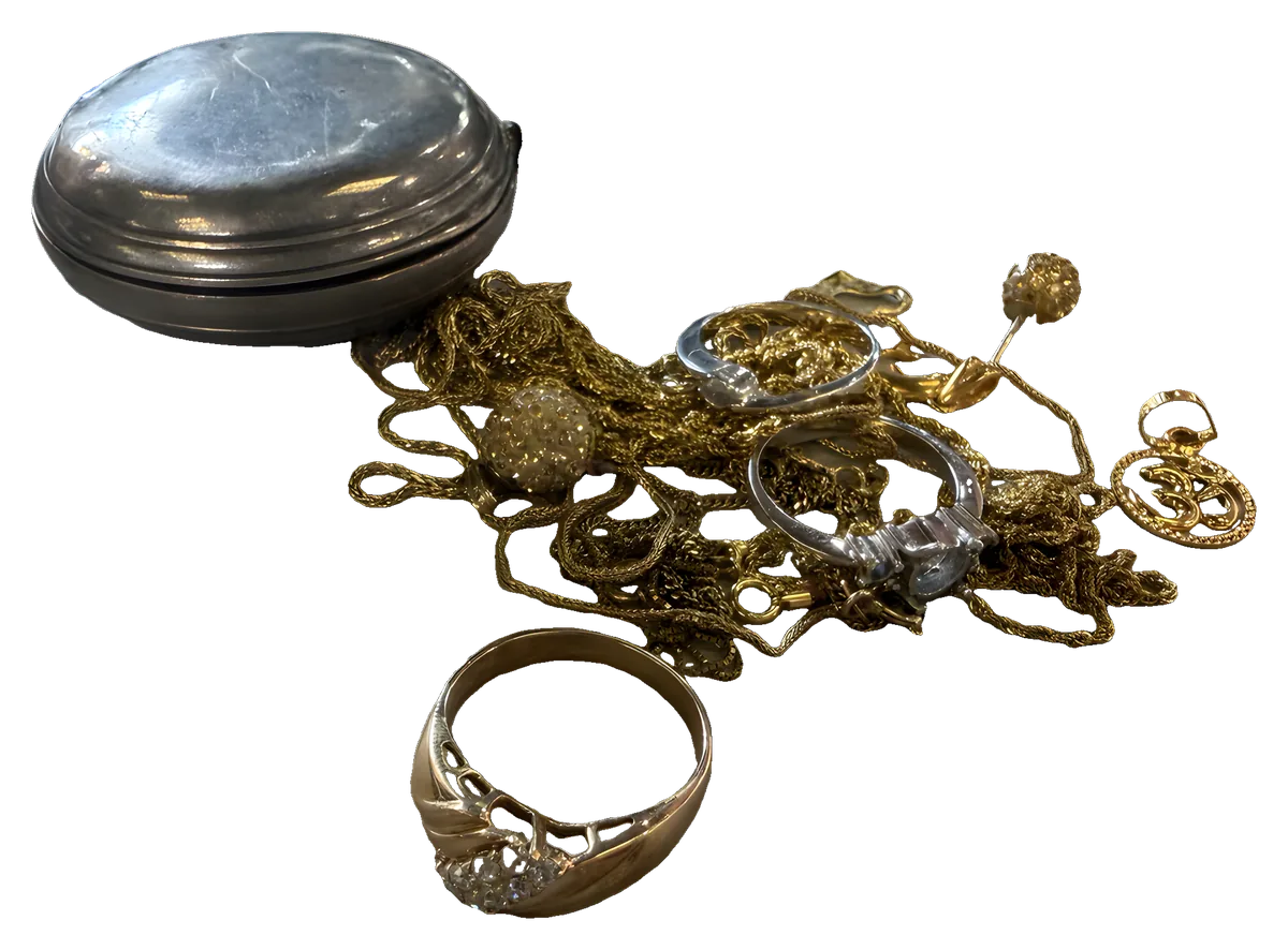 A pocket watch, rings and gold chains brought in to sell